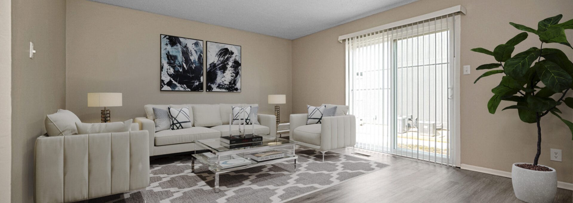 a living room with hardwood floors and a large window at The Windchase Flats and Townhomes
