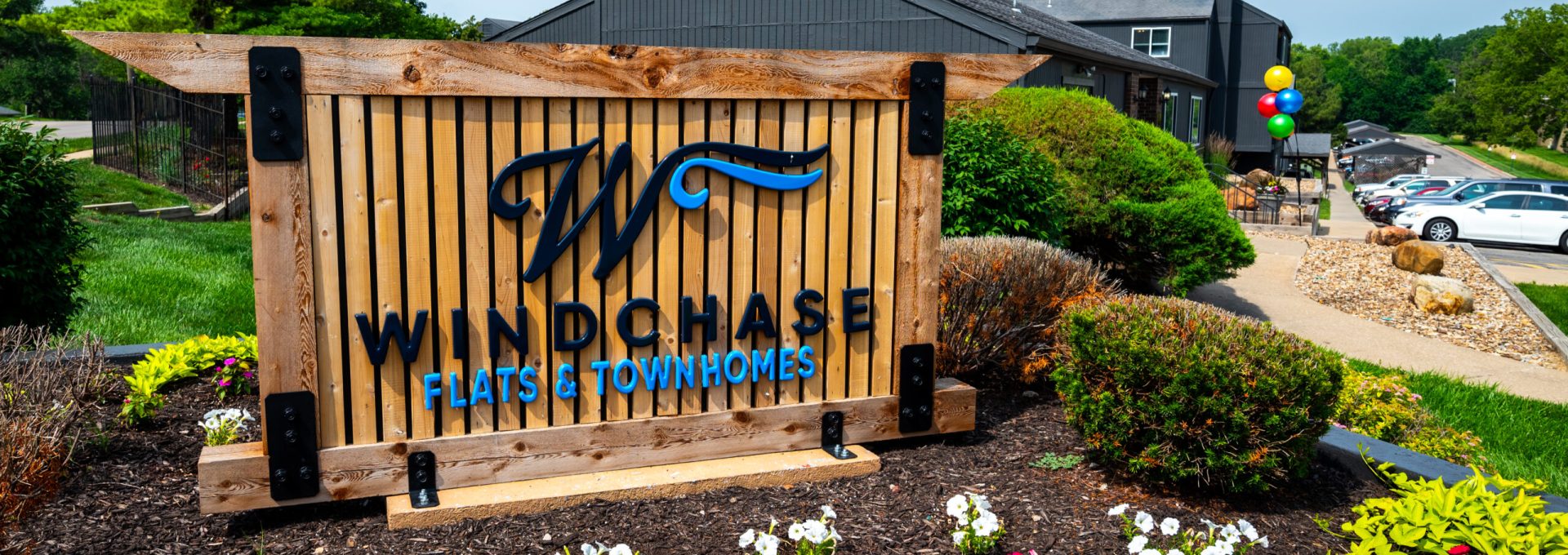 the sign for windsong hotel and resort at The Windchase Flats and Townhomes