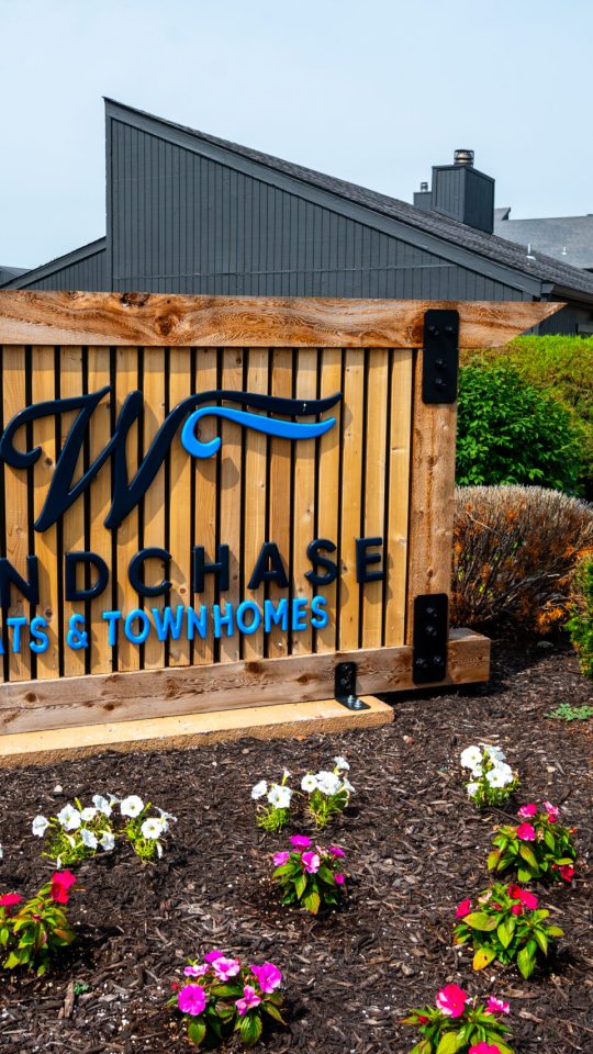 the sign for windsong hotel and resort at The Windchase Flats and Townhomes