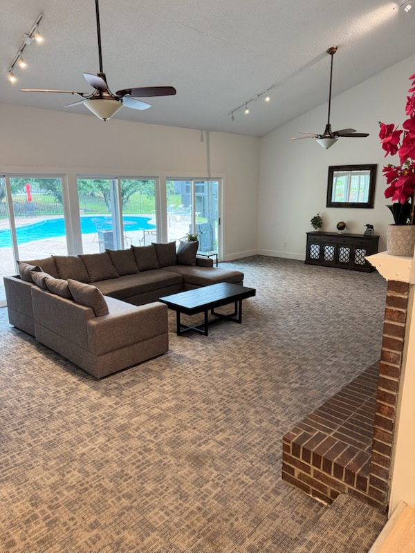 a living room with a fireplace and a pool at The Windchase Flats and Townhomes