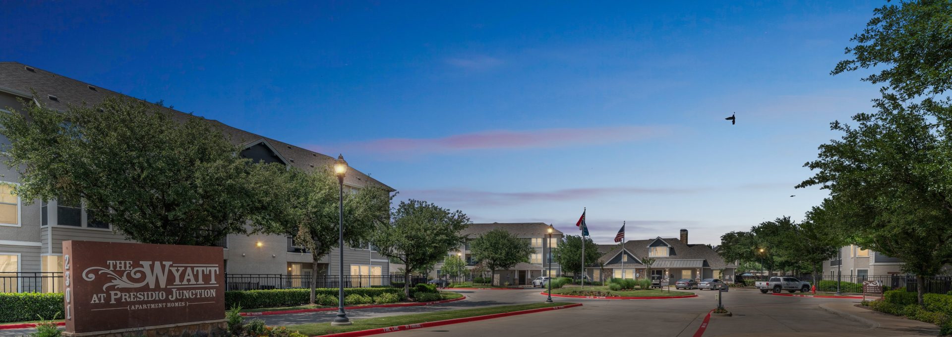 the entrance to a residential community at night at The  Wyatt at Presidio Junction