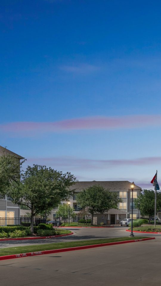 the entrance to a residential community at night at The  Wyatt at Presidio Junction