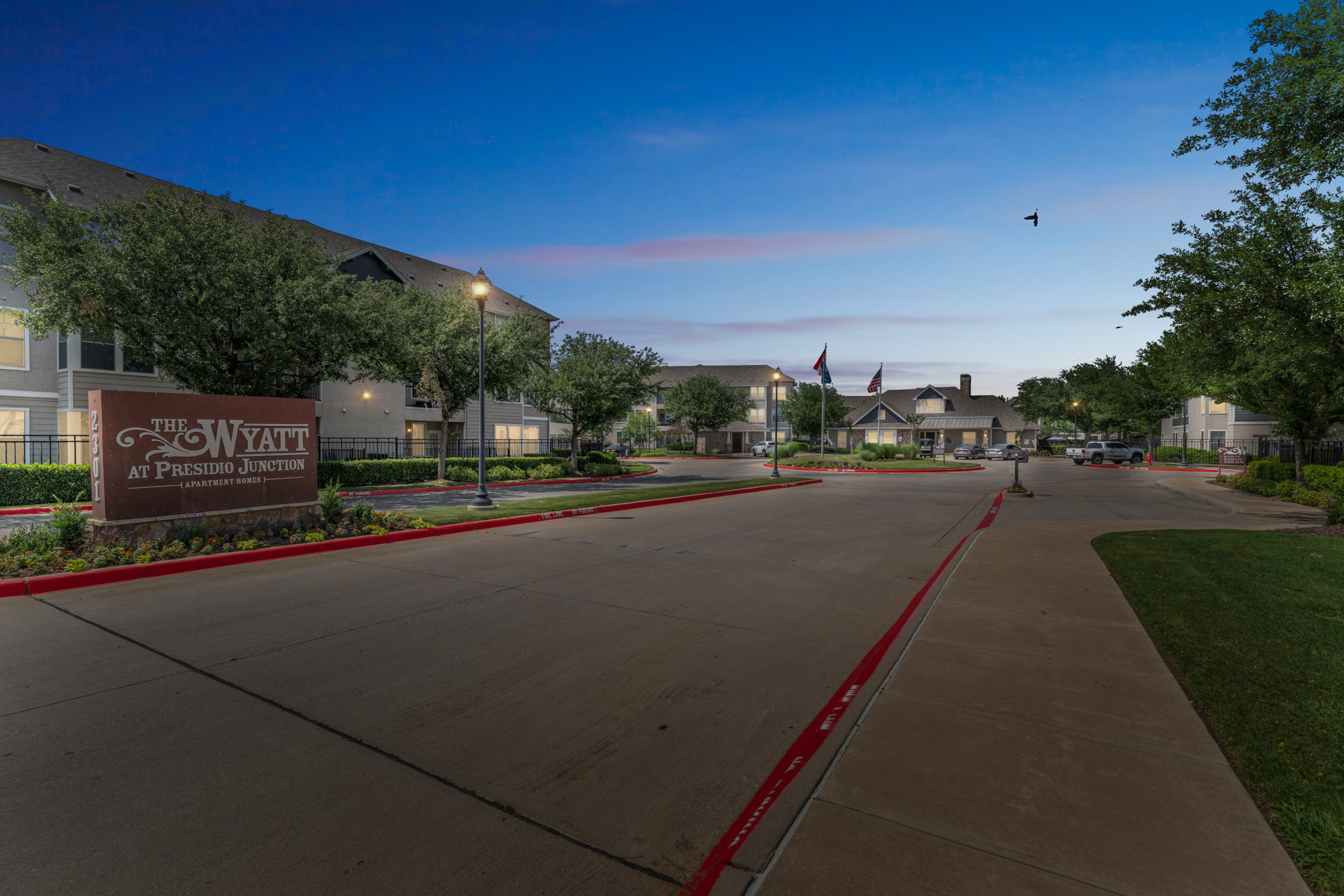 the entrance to a residential complex at dusk at The  Wyatt at Presidio Junction
