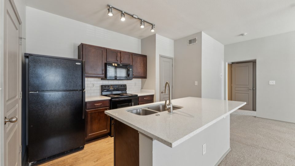 a kitchen with stainless steel appliances and black appliances at The  Wyatt at Presidio Junction