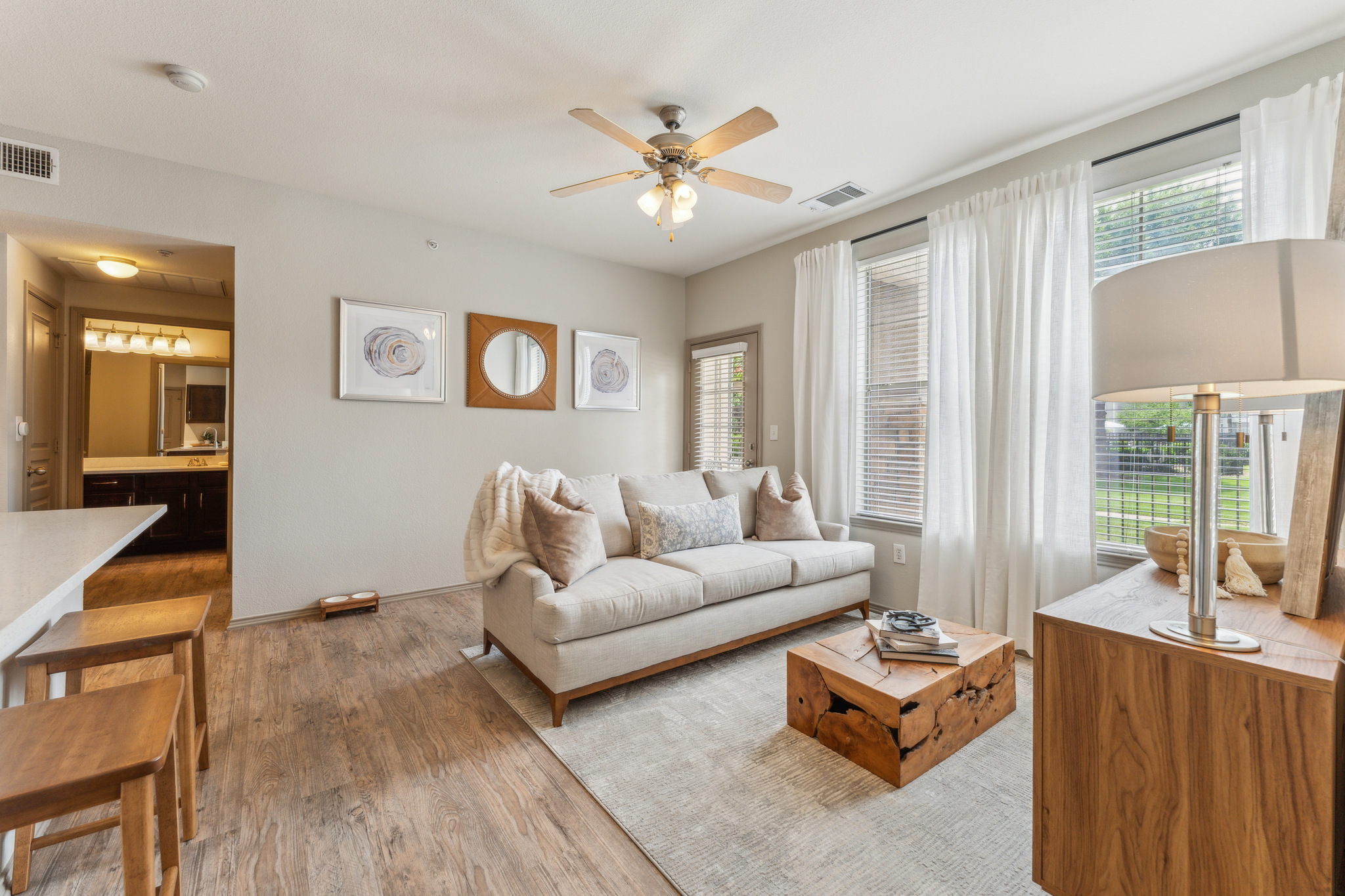 the living room has hardwood floors and a ceiling fan at The  Wyatt at Presidio Junction