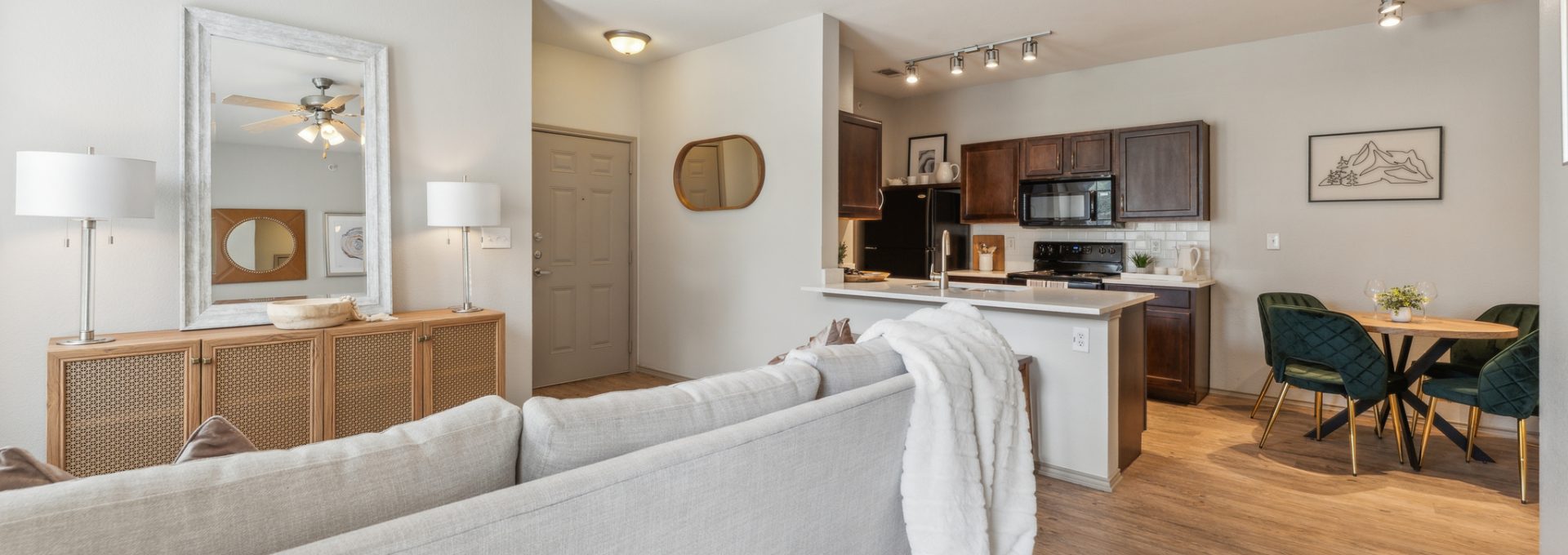 a living room and kitchen area with a ceiling fan at The  Wyatt at Presidio Junction