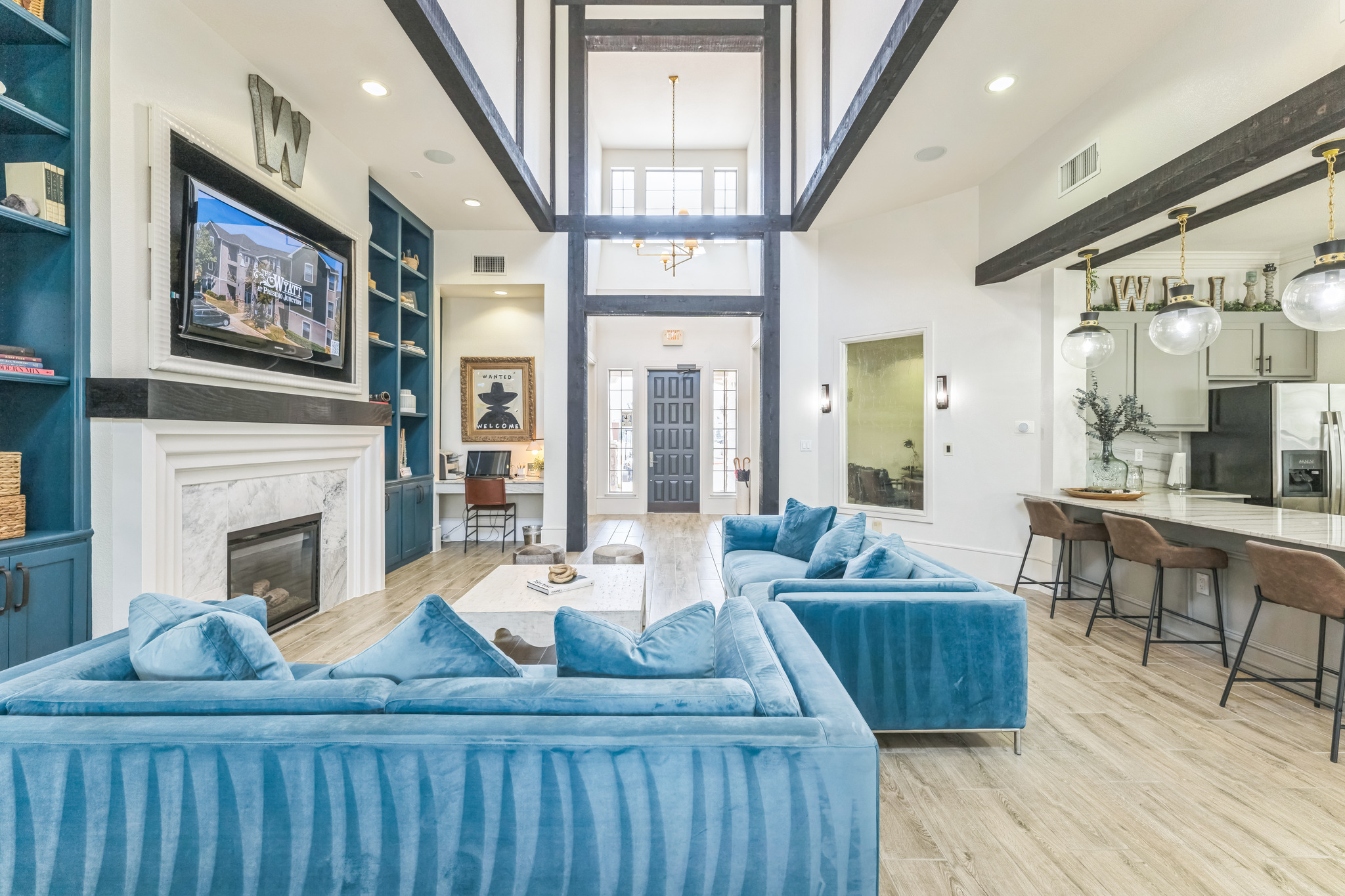 a living room with blue couches and a fireplace at The  Wyatt at Presidio Junction