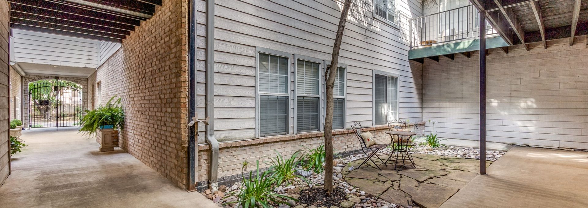 the outside of an apartment building with a patio at The Franconia Court