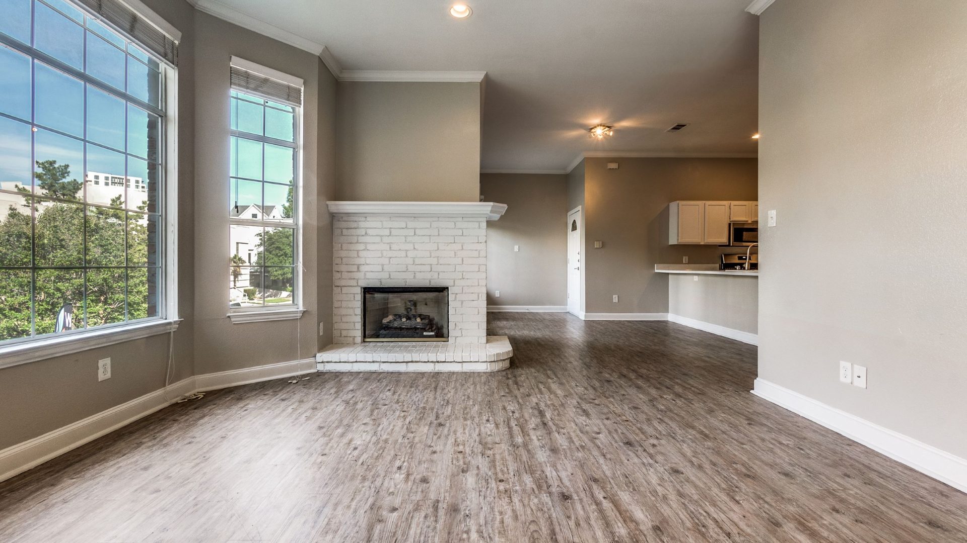 a large empty living room with hardwood floors and a fireplace at The Franconia Court
