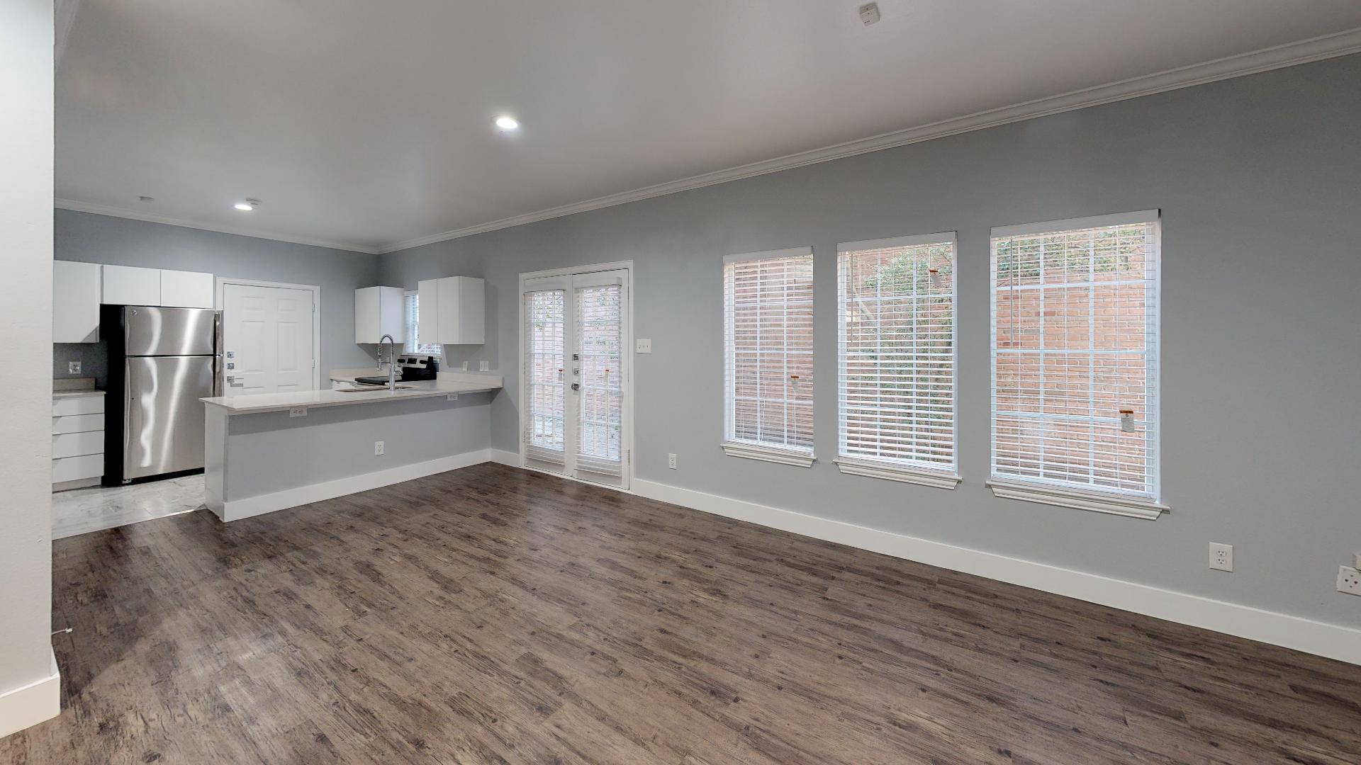 an empty room with hardwood floors and a window at The Franconia Court