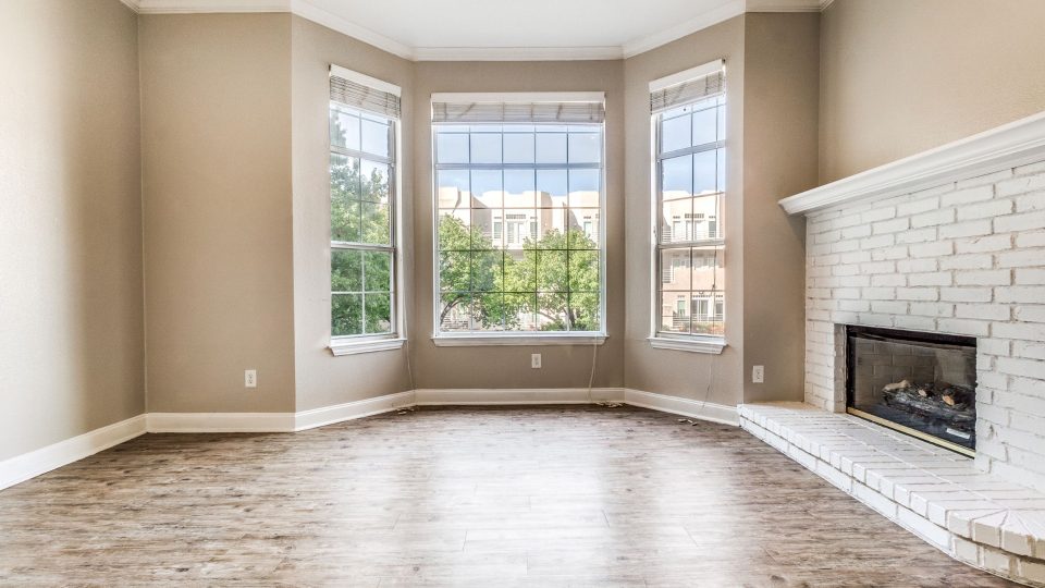 empty living room with fireplace and windows at The Franconia Court