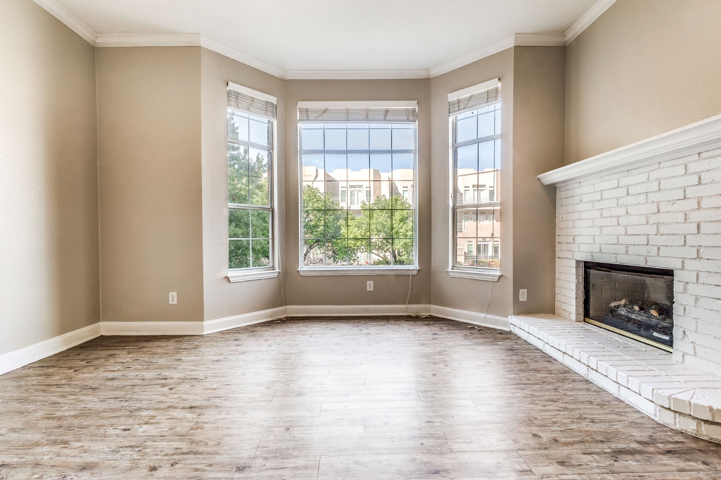empty living room with fireplace and windows at The Franconia Court