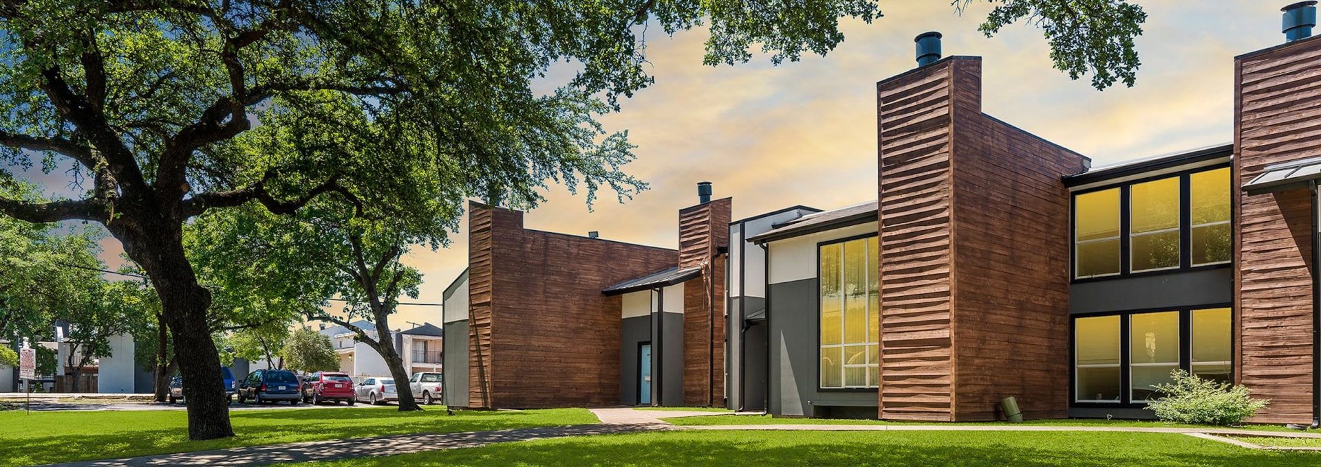 a house with a green lawn and trees at The Southwind