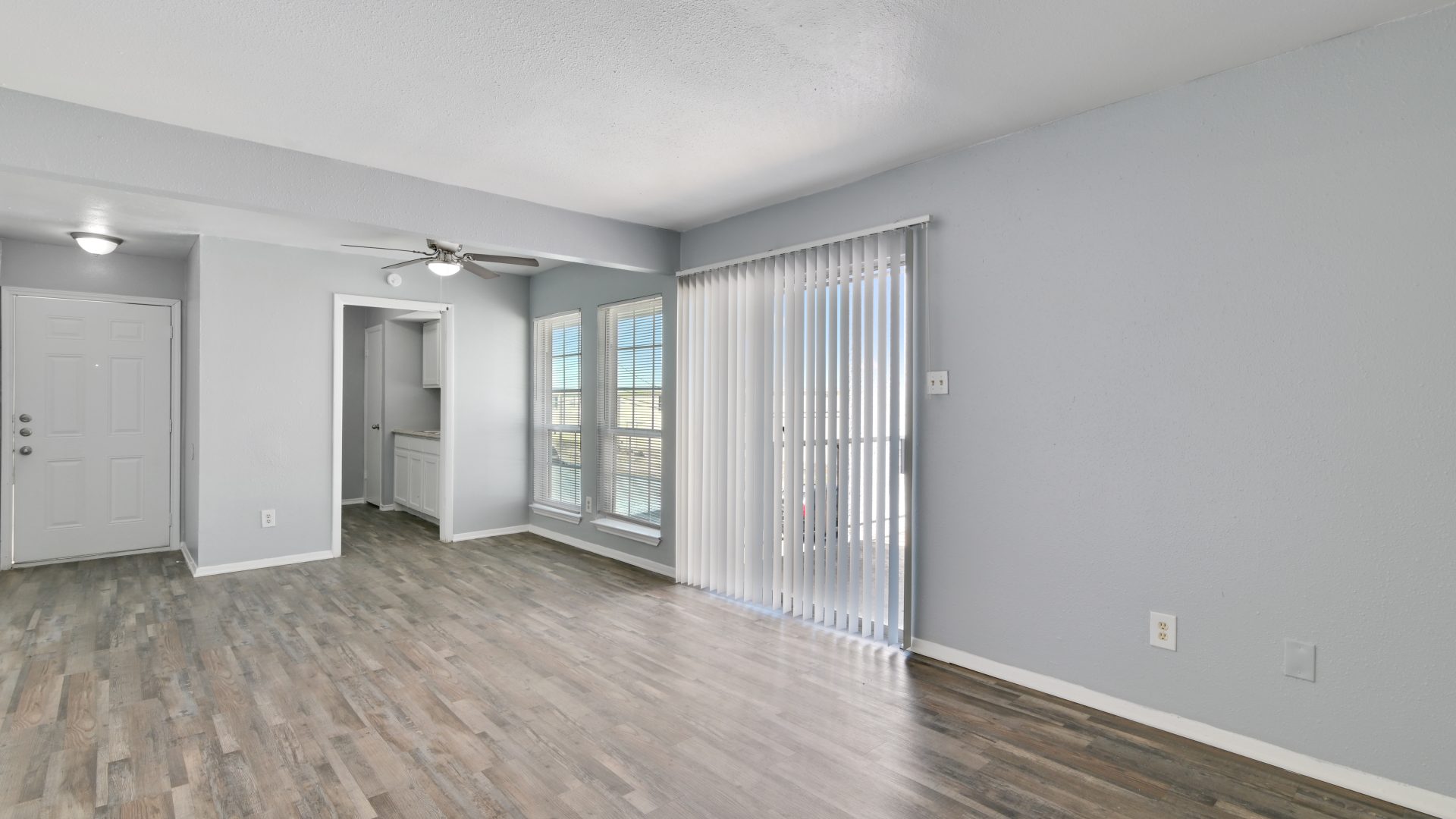 empty room with hardwood floors and sliding glass doors at The Southwind