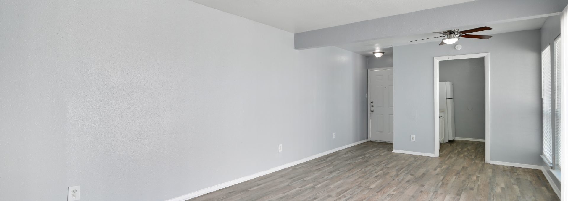 empty room with hardwood floors and ceiling fan at The Southwind