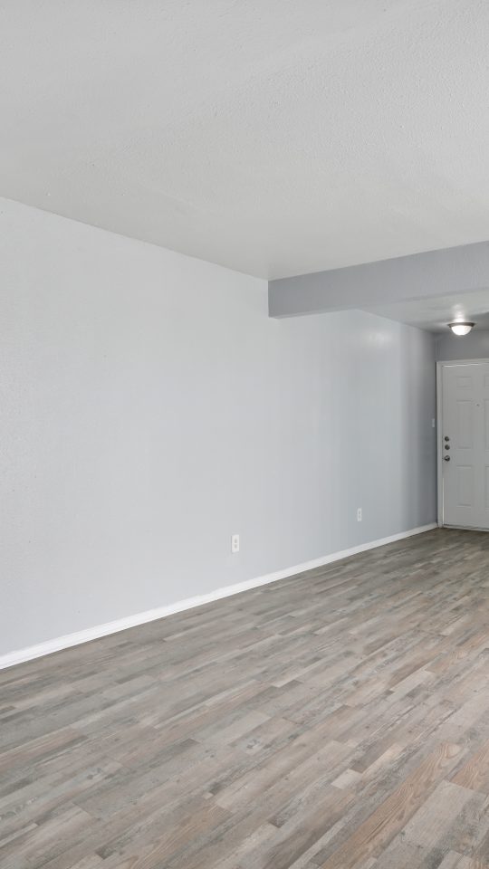 empty room with hardwood floors and ceiling fan at The Southwind