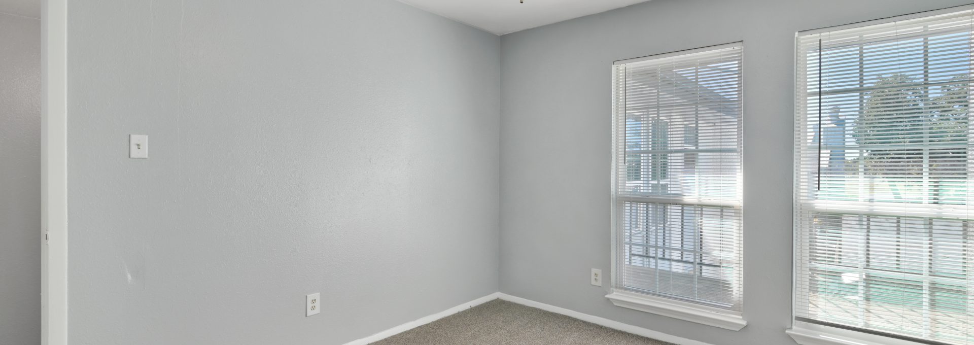 empty room with ceiling fan and carpet at The Southwind