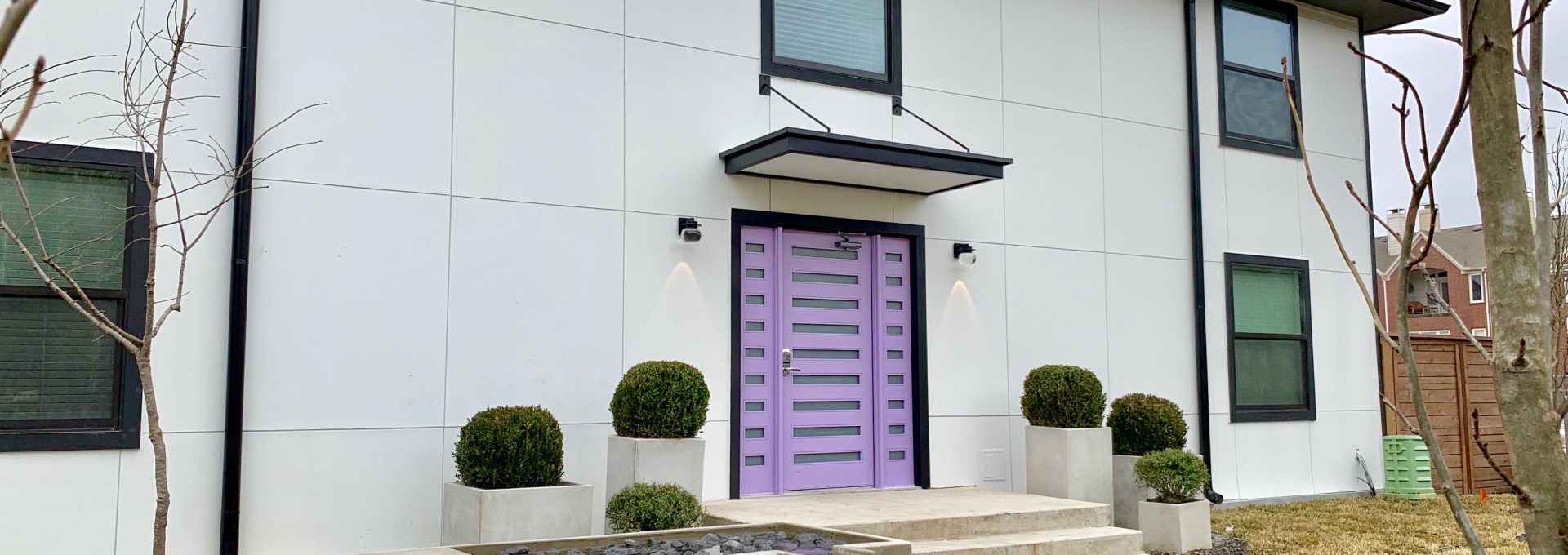 a purple door and a fountain in front of a house at The Flamingo