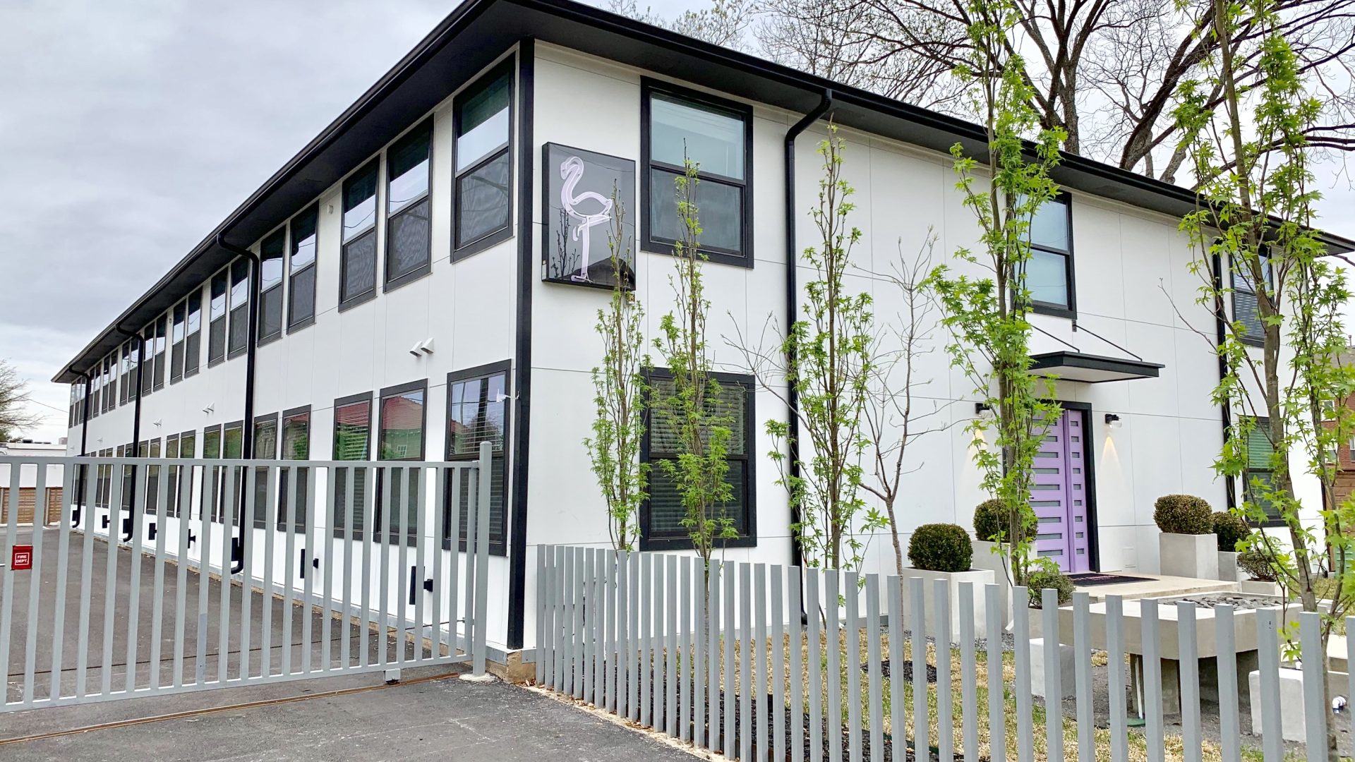 a building with a fence and a gate at The Flamingo