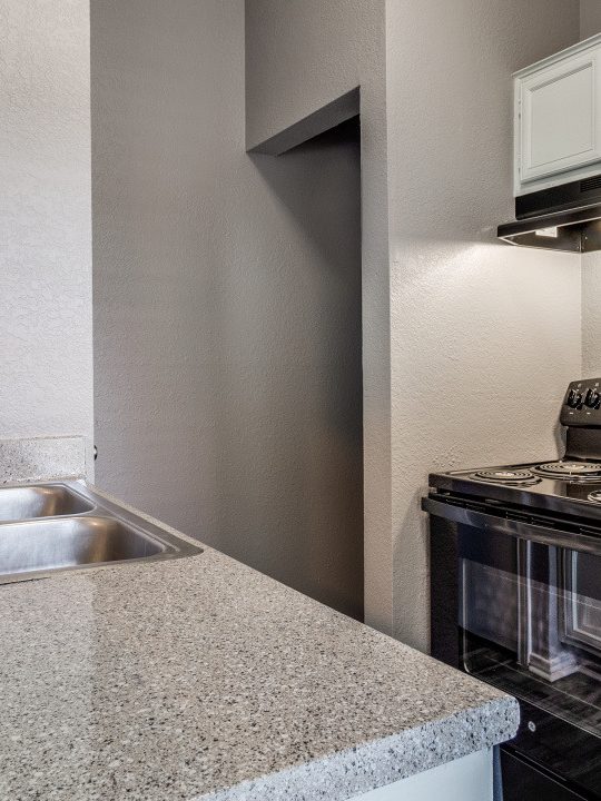 a kitchen with a stove, sink and microwave at The Huntington Brook