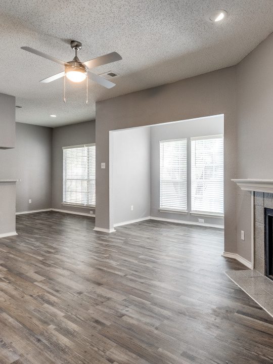 empty living room with hardwood floors and ceiling fan at The Huntington Brook