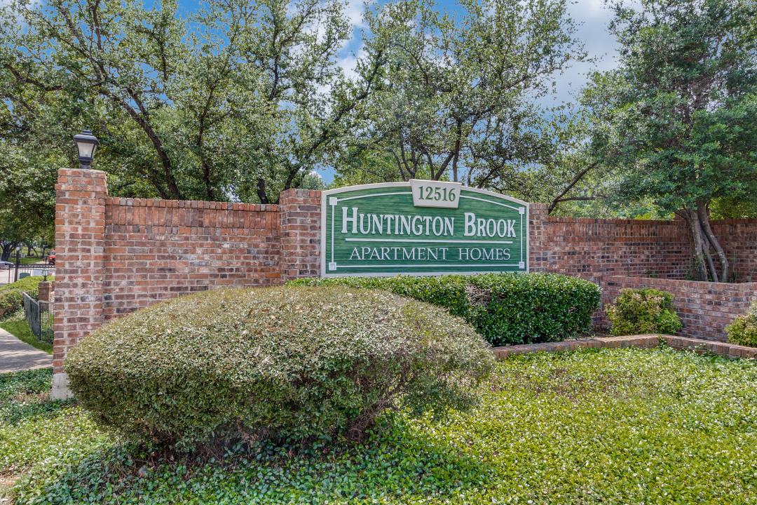 the sign for hinton park apartments in houston at The Huntington Brook