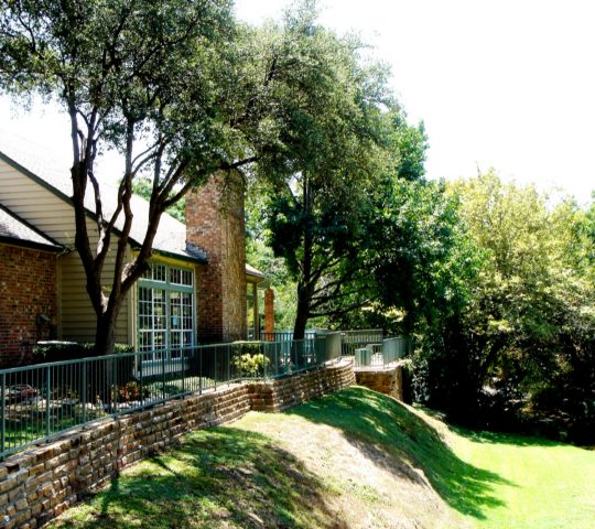 a house with a large yard and trees at The Huntington Brook