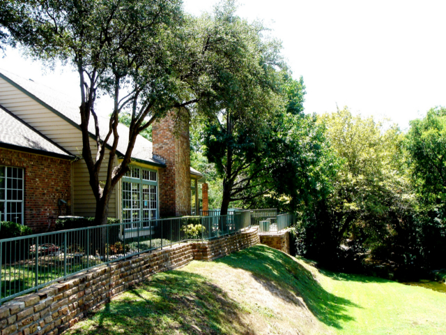 a house with a large yard and trees at The Huntington Brook
