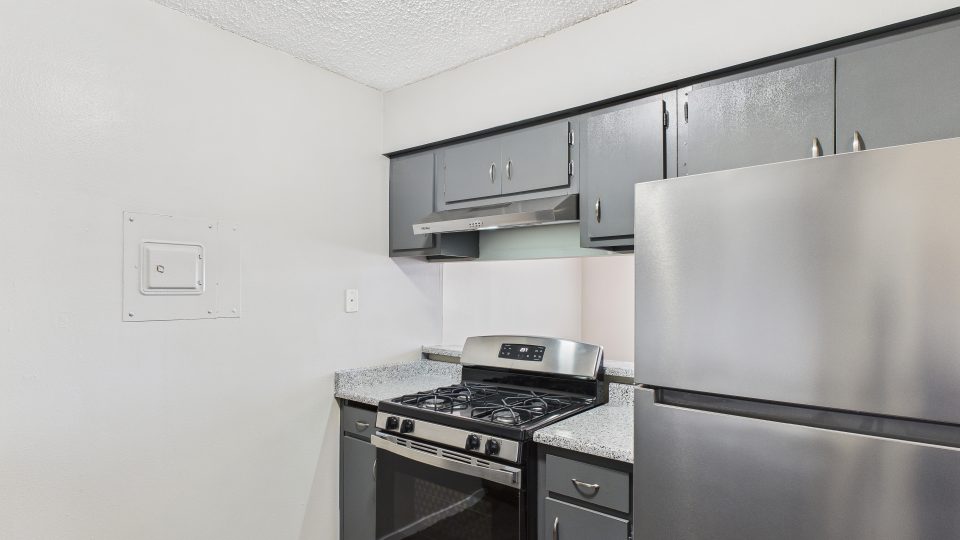 a kitchen with stainless steel appliances and a stove at The Eagle Rock Apartments
