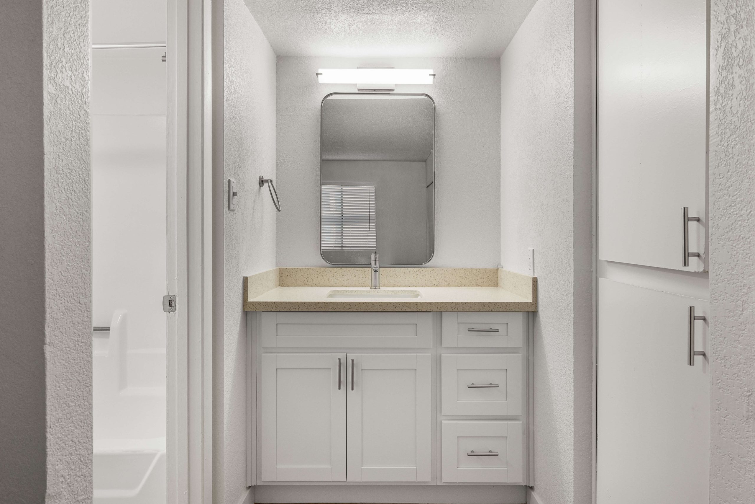 a bathroom with a sink, toilet and shower at The Tides on 27th