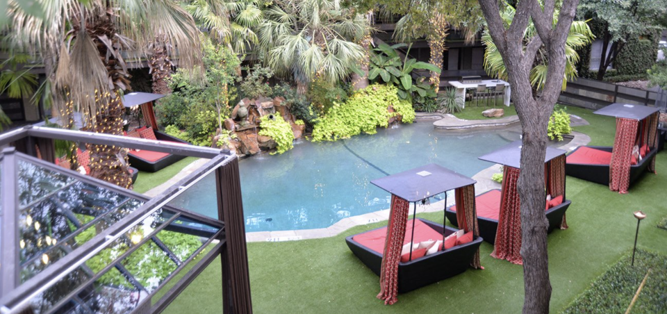 a pool and lounge chairs in a backyard at The Verandah