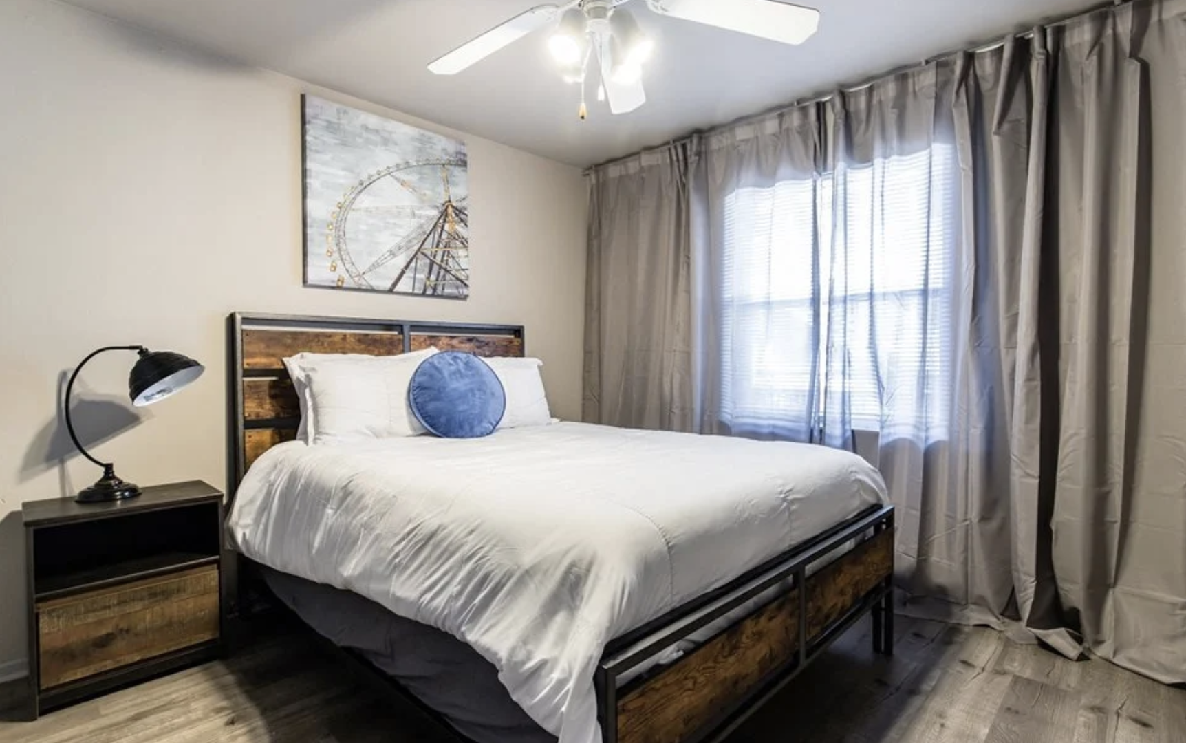a bedroom with a bed, a ceiling fan and a window at The Verandah