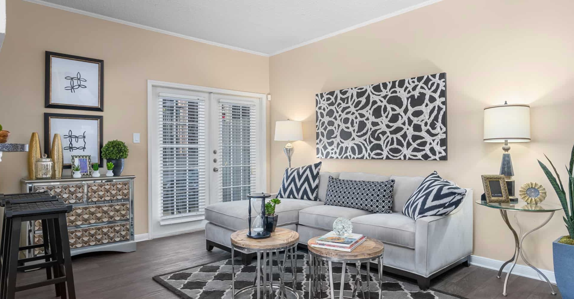 a living room with a couch, coffee table and a television at The  Woodlands Apartments