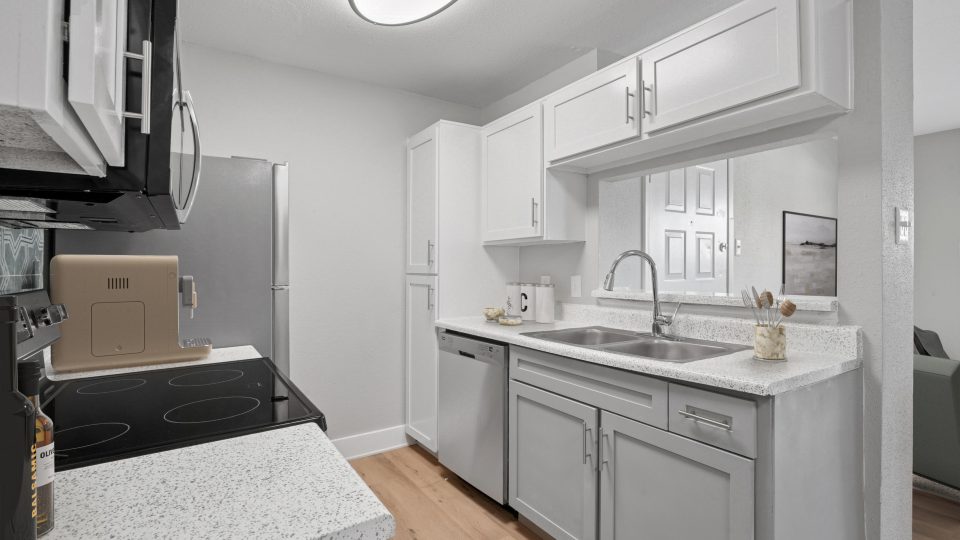 a kitchen with white cabinets and white appliances