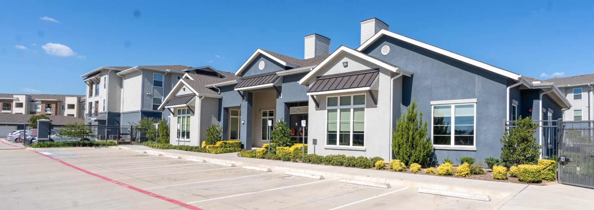 the exterior of a residential apartment complex at The Landmark at Crowley