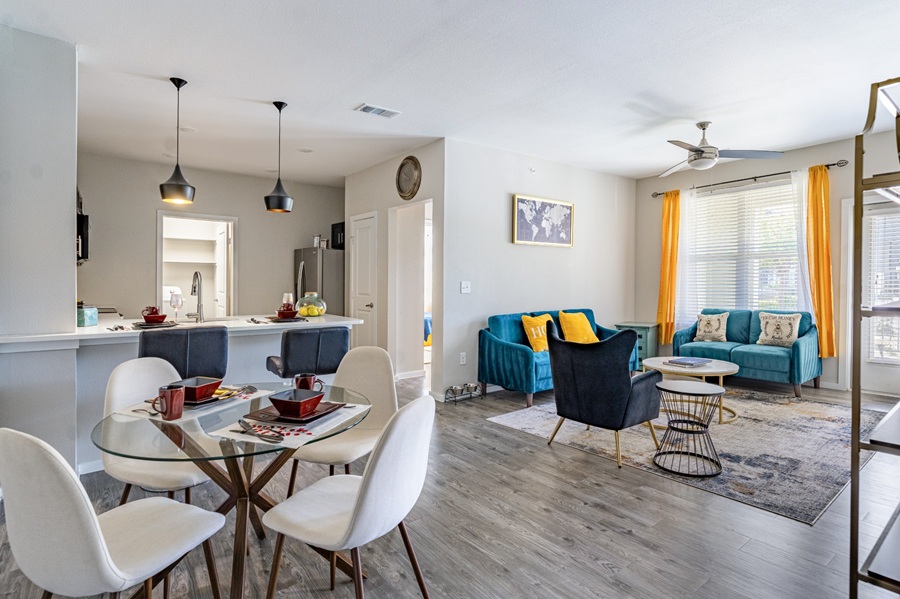 a living room and dining area with hardwood floors at The Landmark at Crowley