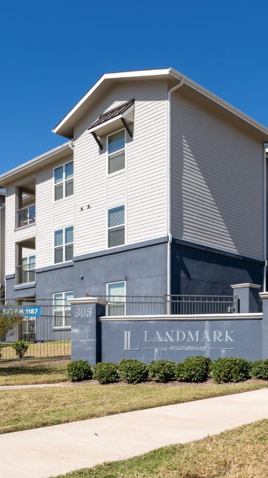 the exterior of an apartment complex with a sign that says, apartment at The Landmark at Crowley