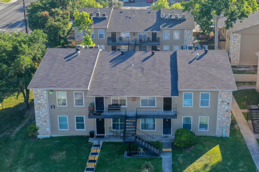 an aerial view of a residential complex with a green lawn at The Calypso Apartments