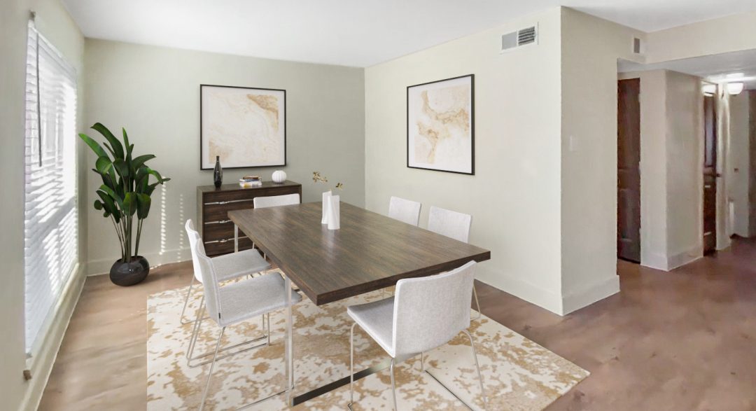 a dining room with a table and chairs at The Park Colony Apartments