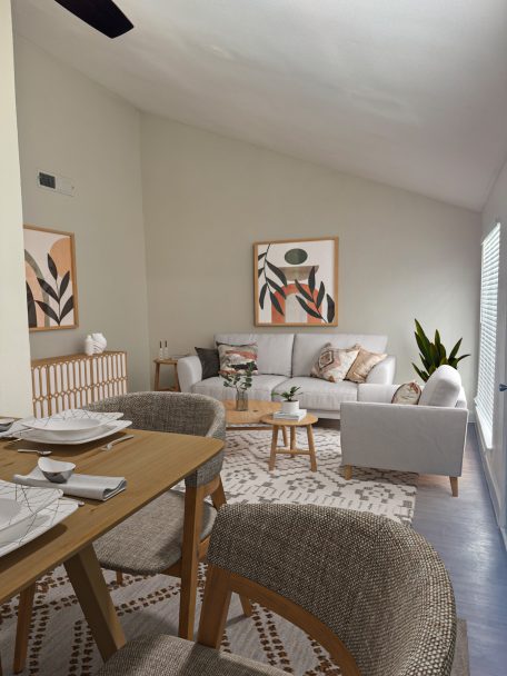 a living room with a dining table and chairs at The Park Colony Apartments