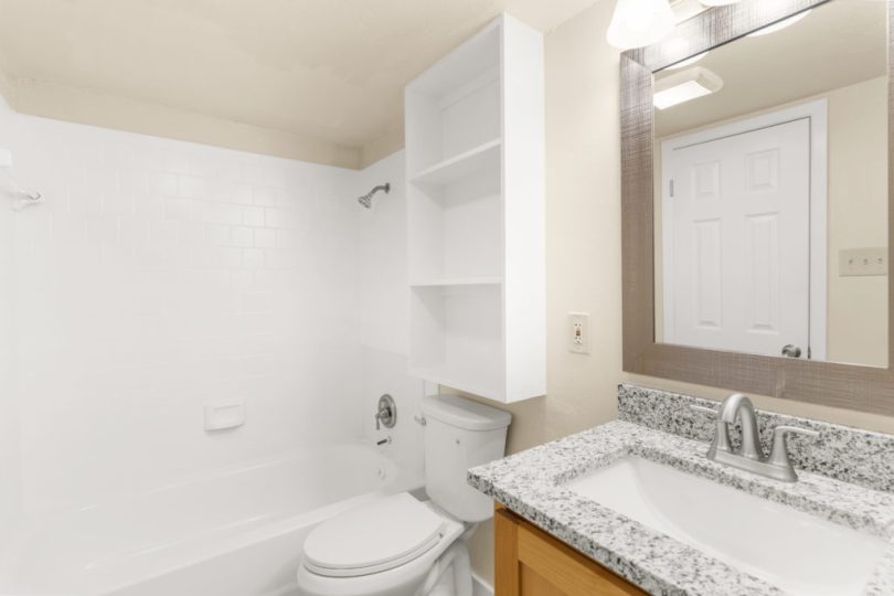 a bathroom with a white sink and toilet at The Delmar Place Apartment
