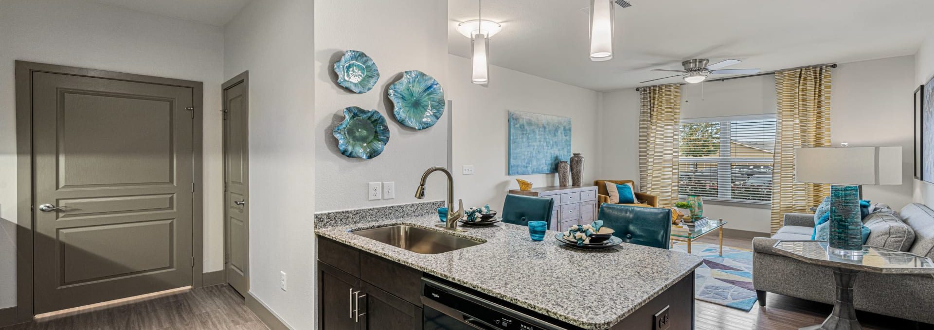 a kitchen and living room area with a blue and white decor at The Panr Hollow