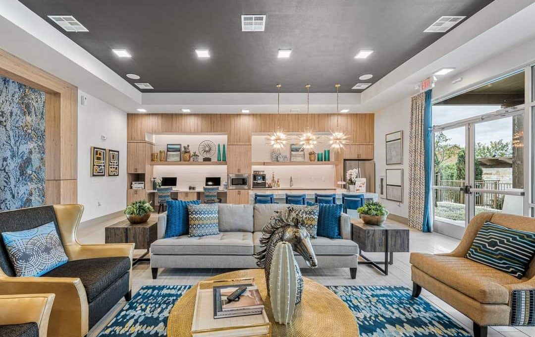 a living room filled with furniture and a large window