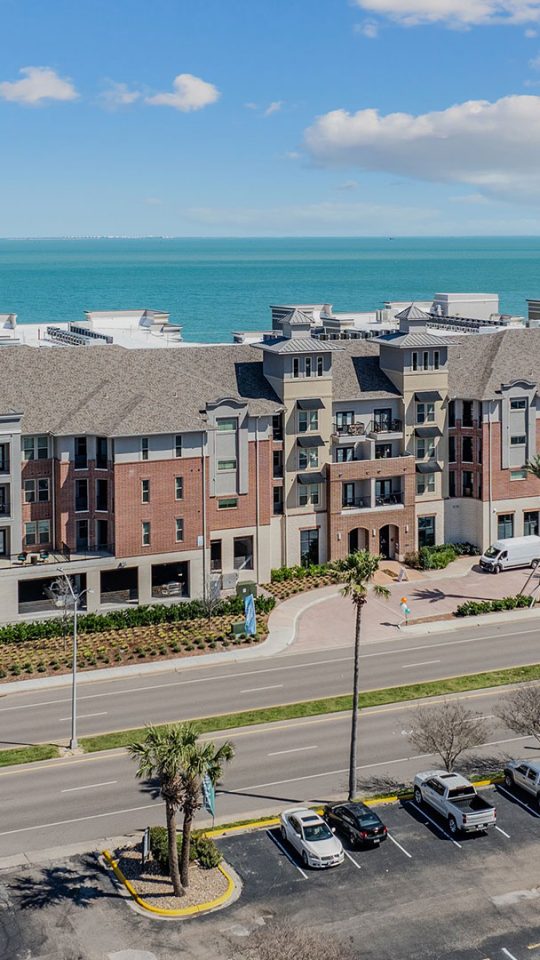 the beach and ocean from above at a condo complex at The Alexa