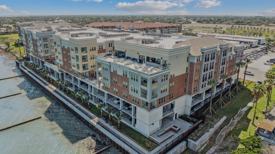 an aerial view of the apartment complex near the water at The Alexa