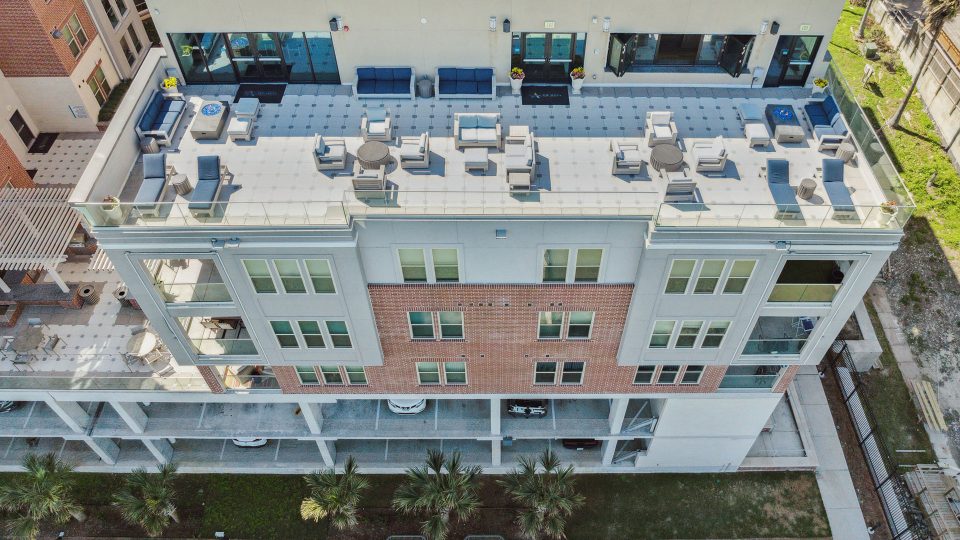 an aerial view of a building with a pool and patio at The Alexa