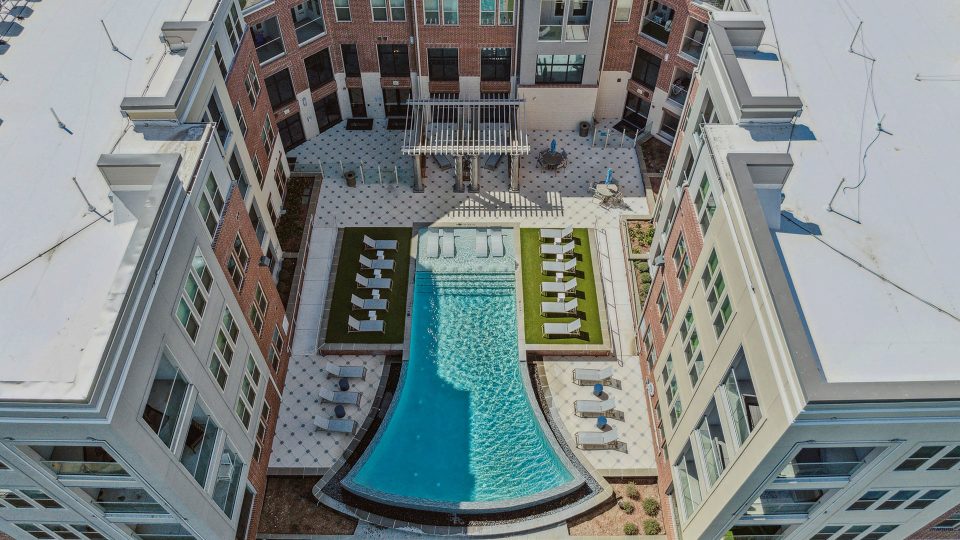 an aerial view of a pool and patio area at The Alexa
