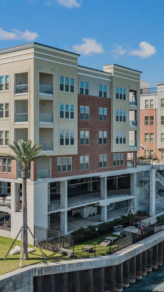 the apartment complex is located on the waterfront at The Alexa