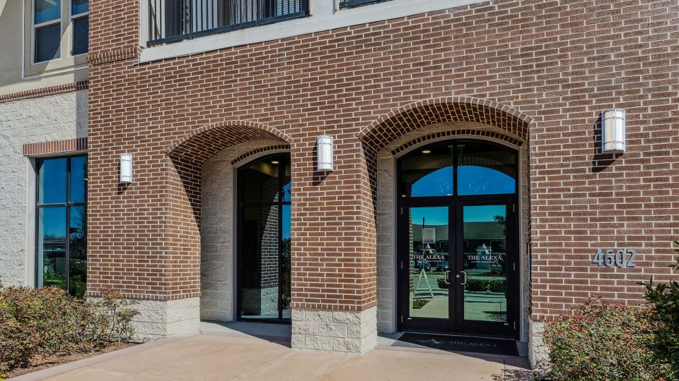 the entrance to a building with two arched windows at The Alexa