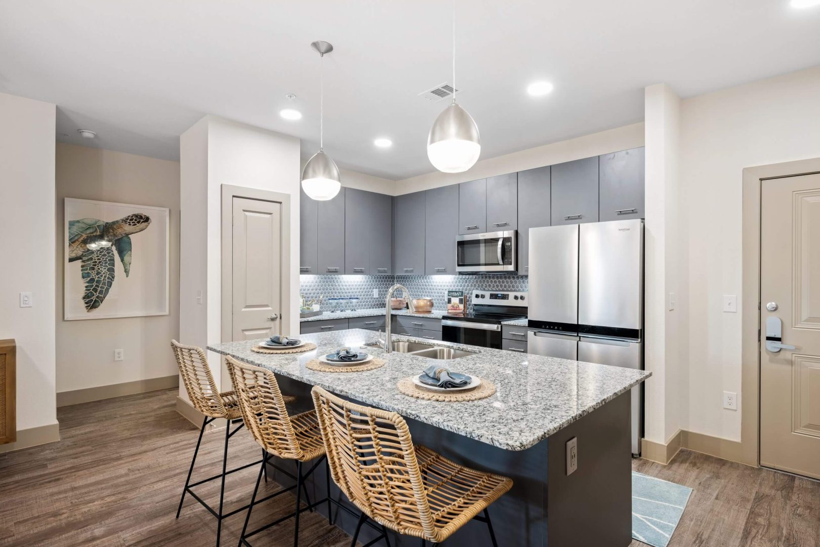 a kitchen with granite counter tops and stainless steel appliances at The  Alexa
